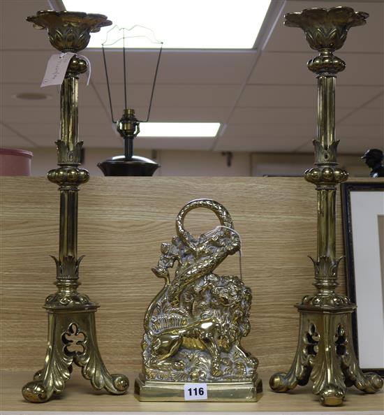 A pair of late Victorian brass altar candlesticks and a door porter, 59cm